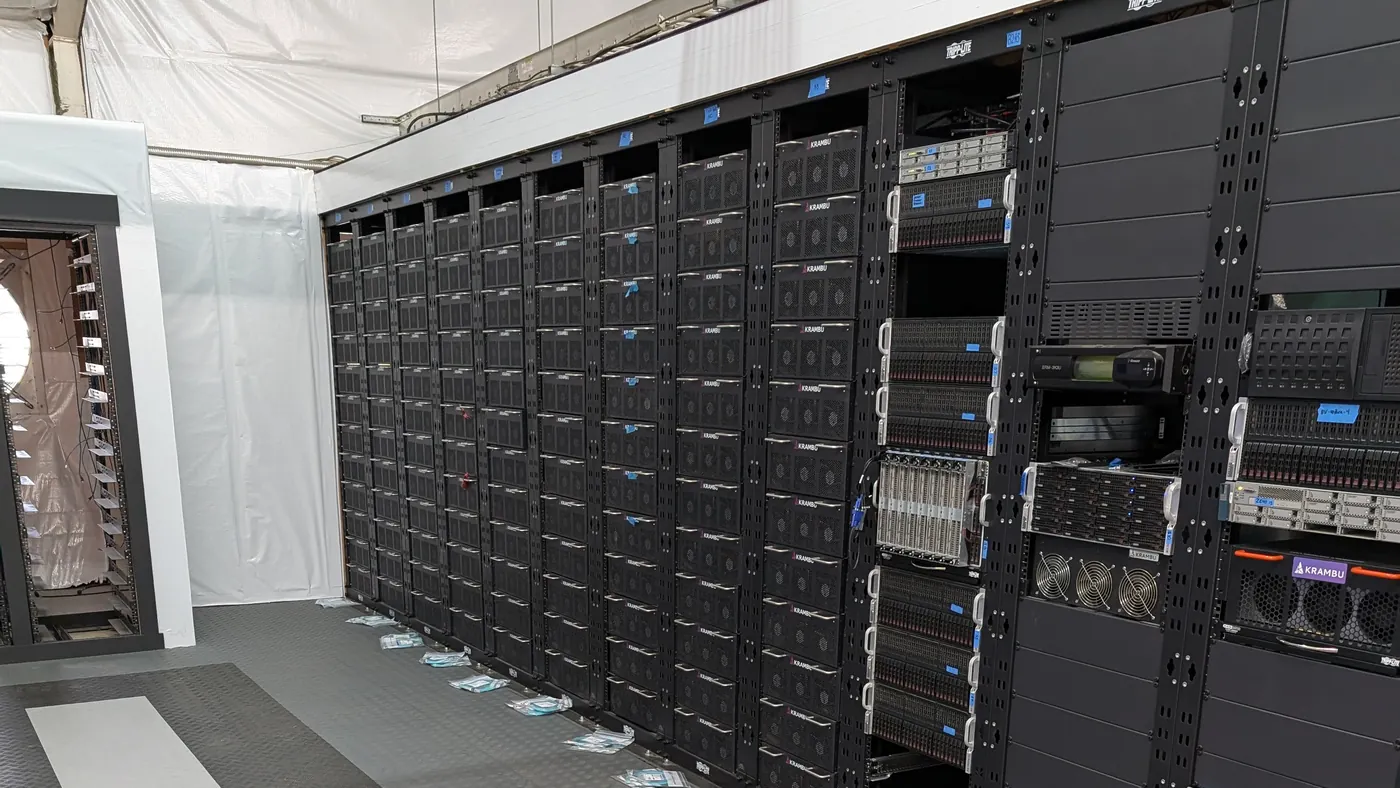 Rows of computing equipment in a server room